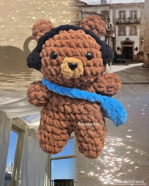 Crochet teddy bear with headphones and a blue scarf